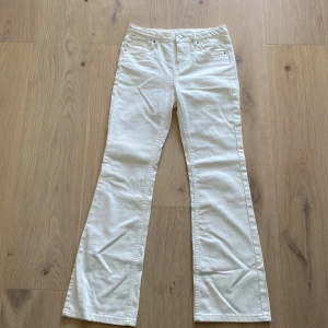 Vita bootcut jeans från Kappahl - Helt oanvända snygga vita jeans från Kappahl i bootcut-modell. Byxorna har bälteshällor och stängs med knapp och dragkedja. Perfekta för dig som vill ha lite mjukare typ av Jeans samt en fräsch och stilren look. Dom ser lite skrynkliga ut på bilderna men när man har på sig dom syns de inte alls. 🩷