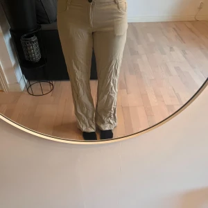 Beige linnebyxorbyxor från Vila - Snygga beige linnebyxor från Vila, storlek L men är på gränsen till försmå för mig och jag har S. Byxorna har knappar och dragkedja framtill samt fickor både fram och bak. 