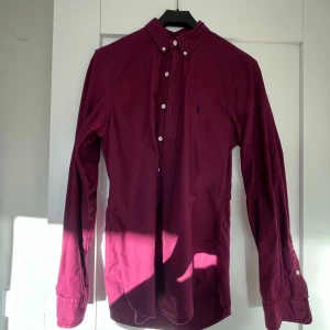 Ralph lauren skjorta  - Vinröd Ralph lauren skjorta i fint skick utöver att det är två fettfläckar på magen där nere. Nu ser på bilderna! 