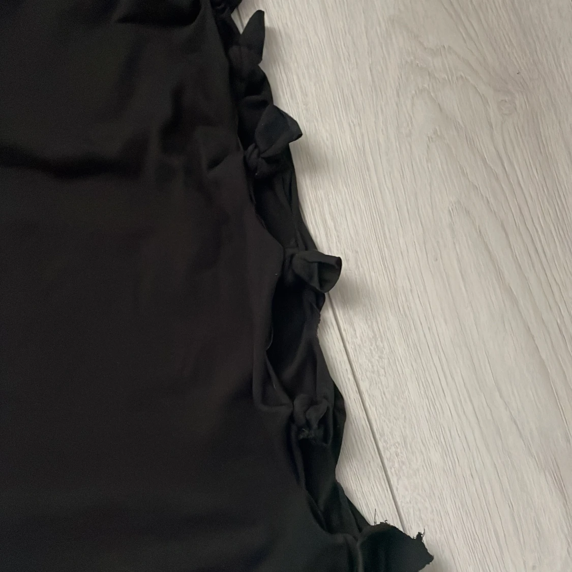 Svart oneshoulder topp med rosetter - 1