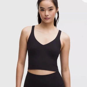 Lululemon align tank - Säljer en svart cropped Lululemon align tank top. Toppen är mjuk och stretchigt, perfekt för träning eller chill. Säljas då den inte används. Den är i storlek 6🌸