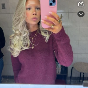 Vinröd stickad tröja med rund hals - Mysig vinröd stickad tröja med rund hals och långa ärmar. Tröjan har en enkel, klassisk design utan synliga detaljer som knappar eller dragkedja. Perfekt för dig som gillar en chill och stilren look. Passar till både jeans och kjol.