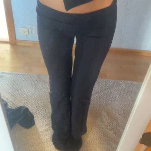 Svarta bootcut byxor  - Säljer ett par svarta bootcut byxor. Höga i strl M, sitter lösare på mig som oftast har strl xs/s så ni får se det ur de perspektivet. De har en snygg, figurnära passform upptill och blir vidare nedtill för en trendig siluett. Perfekta att styla med crop tops eller hoodies. Materialet är mjukt och stretchigt för skön komfort hela dagen.
