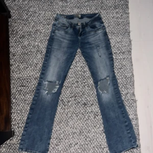 Blå bootcut jeans från LTB - Snygga blå jeans från LTB med slitna detaljer på knäna och klassisk bootcut-passform. Lågmidjade, säljer för de inte vart använda. Är 169 och dom var jätte bra i längden