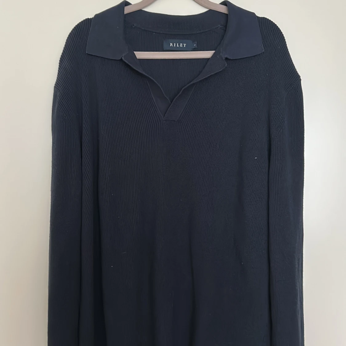 Mörkblå stickad tröja med krage från Riley