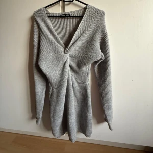 Klänning - Stickad omlottklänning med twistad detalj framtill