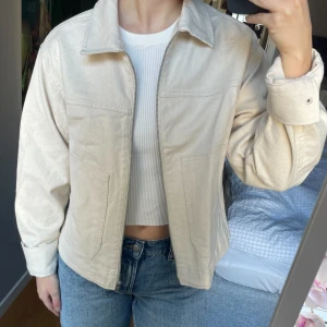Ny ljusbeige jeansjacka med dragkedja  - En riktigt snygg helt ny ljusbeige jeansjacka med silverdragkedja och fickor, från ASOS! Slutsåld på ASOS, produktkod: 138684803. Köpte den för 599kr. Storlek small. Normal i storleken. Prislappen kvar. Jag missade tyvärr returpolicyn och kunde inte returnera den (beställde fler storlekar), därför försöker jag sälja den här.