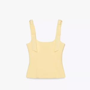 Gul topp från zara - Snygg ljusgul topp med breda axelband som knyts i rosetter. Aldrig använd då den tyvärr är för liten.