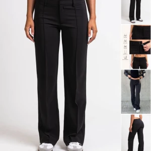 Svarta kostymbyxor från Madlady - Snygga svarta kostymbyxor från Madlady med medelhög midja och raka ben, de har fickor fram till men inte bak! Säljer då de inte kommer till användning och är aningen för små, de är i fint skick men har lite knottror i rumpan, storlek 38