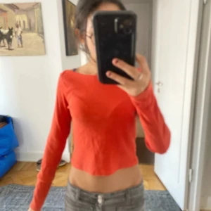 Röd croppad långärmad tröja från Gina Tricot - Säljer en röd croppad långärmad tröja från Gina Tricot. Tröjan har en ribbad struktur och en enkel, tight passform.