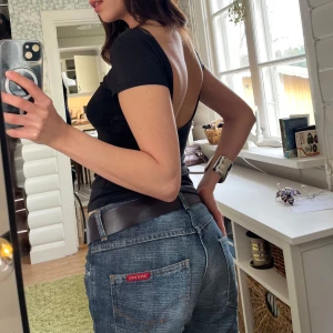 T-shirt med djup rygg från Weekday - Snygg svart tight t-shirt från Weekday med korta ärmar och en djup, öppen rygg. T-shirten är i mjukt material och har en enkel design, perfekt till fest eller för sommaren!🫶