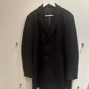 Svart rock från Hugo Boss - Säljer en svart rock från Hugo Boss köpt för nypris ca 7000kr. Den är i storlek Large.