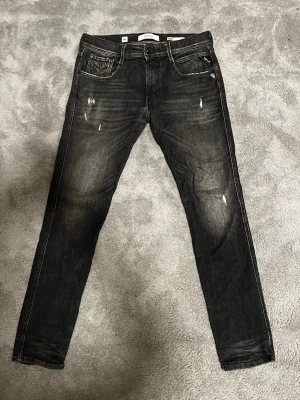 Svarta replay jeans med slitningar  - Tja! Säljer ett par svarta Replay jeans slim fit med snygga slitningar och bra tvätt. Nypris 1800 kr. Inga defekter på jeansen eftersom de är knappt använda. Fraktar inom 24 timmar. Hör av dig vid fler funderingar!🙌