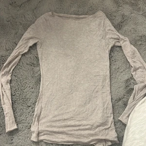 Beige  långärmad tröja Intimissimi S - Supermjuk och tunn ljusbeige långärmad tröja från Intimissimi i bomull och kashmir. Enkel och stilren modell med rund halsringning, perfekt att ha som basplagg eller under tröjor. Sitter tajt mot kroppen och är riktigt skön mot huden.dock två hål, en på varje arm det syns inte för dem är inte stora alls❤️köpte för kanske nån månad sen, har använt den kanske 4 gånger, köpte för 500 säljer 250 därav hålen!