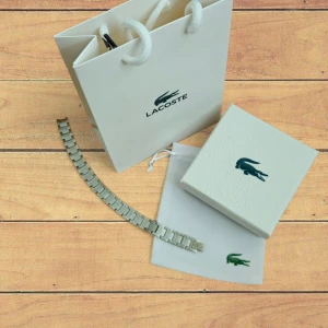 Silver armband Lacoste - helt ny Lacoste armband silver med tillbehör, 1t1.