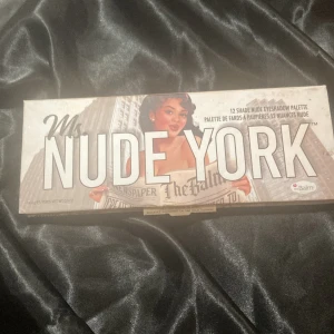 Ms. Nude York ögonskuggspalett The Balm - Bara testad helt ny, ögonskuggspalett från The Balm med 12 nude nyanser. Paletten innehåller både matta och skimrande skuggor i guld, rosa, brons, beige, bruna och taupe toner. Perfekt för dig som gillar naturliga och mjuka looks. Snygg retroförpackning i kartong.