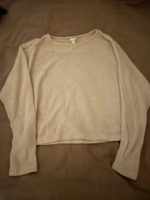 Beige stickad tröja från H&M - Säljer en beige stickad tröja från H&M i storlek S. Tröjan har en enkel och clean design med rund hals och långa ärmar. Materialet är mjukt och har en tydlig stickad struktur som ger en chill vibe. Perfekt för lager-på-lager under hösten och vintern.