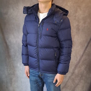 Ralph Lauren Dunjacka - Stl Xl 18-20/ S - 🗻 Snygg och populär dunjacka från Ralph Lauren perfekt nu på vintern! 🗻 Mycket bra skick: 9/10 förutom 2 pyttesmå slitningar på ärmen och en patch på insidan av jackan som lossnat, samt den man hänger upp jackan med är lös på ena sidan | Stl Xl 18-20 som är en barnstorlek men passar Herr S, Modellen på bilden är 175cm lång, rekommenderar att vara mellan 166-178cm för att sitta fint! | 