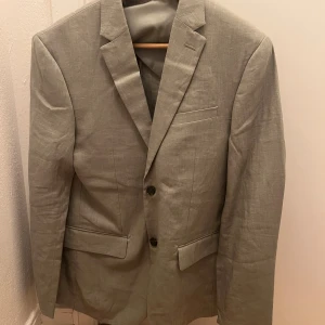 H&M Linnekavaj salviagrön - Som titeln lyder. Den är ALDRIG använd enbart prislappen borttagen, har bara hängt i garderoben. Nypris på HM's hemsida är 1000 kr. Lite dåligt ljus på mina bilder därför har jag lagt in sista bilden för kontext. Storlek 46. 