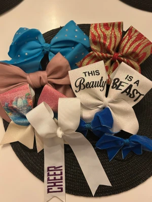 Glittrig cheer rosett med text - Säljer cheer rosetter. Vissa av rosetterna är gjord i ett grovt ribbat tyg och har klassisk stor form som passar perfekt till cheerleading eller dans. Superfin att ha i håret för att sticka ut på träning eller tävling. Alla är köpta under cheertävlingar de stora är köpta för 699kr och de små för 350kr men pris diskuteras😊