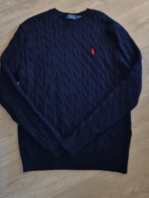 Ralph lauren tröja - Fin kabelstickad tröja från Ralph Lauren i färgen navy, helt ny! Storlek S men passar även M. Hör av er vid frågor eller funderingar! 