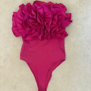 Rosa body från Zara!! - Jättefin rosa body från Zara med volanger på! Perfekt för fest!! Den har en liten defekt som jag visar på 3e bilden!! 