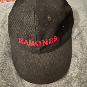 Keps med broderad text Ramones - Helt ny keps med broderad text Ramones. Reglerbar bak. 