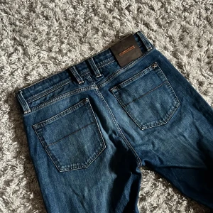 Tramarossa Michelangelo - Säljer dessa riktigt snygga Tramarossa jeans i modellen Michelangelo. Jeansen har en slim/straight passform och är i bra skick förutom att ena knappen saknas se bild 3. Bara att skriva över frågor och funderingar.