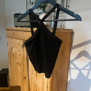 Svart topp - Svart topp med sneda axelband 