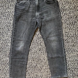Levi's 551Z svarta jeans W34 L32 - Svarta Levi's 551Z jeans med klassisk femficksdesign och rakt snitt. Jeansen har en snygg tvättad finish och är tillverkade i en mix av bomull och hampa. Perfekta för dig som gillar en avslappnad och tidlös stil. Sparsamt använda, så väldigt fint skick.