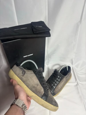 Saint Laurent skor  - Storlek 39, passar 40. Lite grå/svart färg. Inga defekter. Allt og medkommer utom snören. Retail 9000kr. Där är tuggummi fast på skon på en sida fram och under skol och lågan på skon är solblekt så svårt läst men det ska va en söndrig modell så det är designen lite på dem så jag själv tycker dem är riktigt feta. Ingen retur!