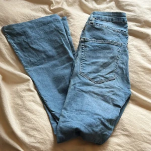 Ljusblå flare jeans - Snygga ljusblå jeans från 157 med klassisk femficksdesign och utsvängda ben. Modellen heter Snake Flare och har normal passform med dragkedja och knapp framtill. Perfekta för dig som gillar retrovibbar och vill ha ett par bekväma jeans i bomull.