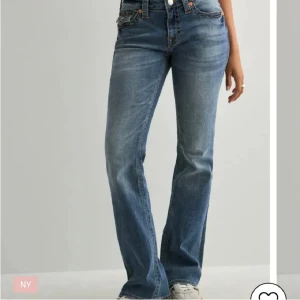 Blå bootcut jeans från True Religion - Snygga blå jeans från True Religion med bootcut passform och låg midja. Jeansen har klassiska orangea kontrastsömmar och detaljerade fickor med lock och silverknappar bak. Materialet är slitstarkt denim och byxorna har en bootcut passform. De är i storlek w24. Köpte för 1599kr och pris går att diskutera😊❤️