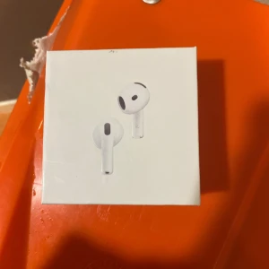 AirPods 4 with Active Noise Cancellation - Nya Apple AirPods 4 med aktiv brusreducering. Levereras i originalförpackning, kompatibla med trådlös laddning och USB-C. Perfekt för musik, samtal och vardagsbruk. Kartongen är i gott skick med endast mindre märken.