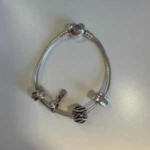 Pandora armband - Superfint pandora armband som jag tröttnatt på. Orginalpris för allt: 2550kr. Den har två stopp grejer och två berlocker.🌟