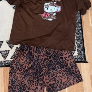 Hello Kitty Bruna leopardmönstrade shorts - Säljer ett par bruna shorts med svart leopardmönster. De har en loose passform och resår i midjan för extra komfort. Perfekta för dig som vill sticka ut med ett djurmönster i sommar. ( liten i stolek !!!!!!)