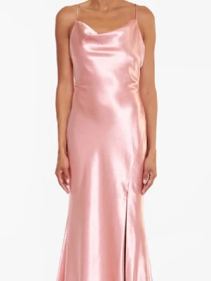 Lång rosa satinklänning med slits - Supersnygg lång klänning i glansig rosa satin med tunna axelband och öppen rygg med knyt. Klänningen har en elegant slits framtill och ett mjukt fall som ger en lyxig känsla. Perfekt för dig som vill sticka ut på bal eller fest. Klänningen har två små fläckar längst ner på släpet men det är inget som syns när man har klänningen på sig🩷