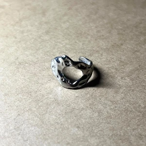 Æther Silver Hollow - An asymmetrical sculpture in motion — void meets form in stainless steel. Adjustable & rust-free