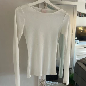 Vit långärmad tröja från Nelly - Snygg vit långärmad tröja från Nelly i storlek S. Tröjan har en enkel och clean design med rund hals och smal passform. Perfekt att styla med jeans eller kjol för en fräsch look. Materialet känns mjukt och lätt mot huden.
