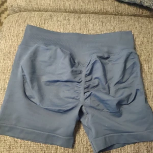 Blå scrunch shorts M - Blåa "scrunch" shorts i storlek M, true to size. Tyvärr ytterst lite för stora för mig, säljer därav. Sjukt snygga! Mjuka och stretchiga, klämmer inte åt någonstans! Helt nya men utan lapp.