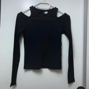 Svart långärmad topp med cut out - Säljer min snygga svarta långärmad topp då den tyvärr inte kommer till användning. Väldig bra skick då den bara är använd ett fåtalgånger!💕💕
