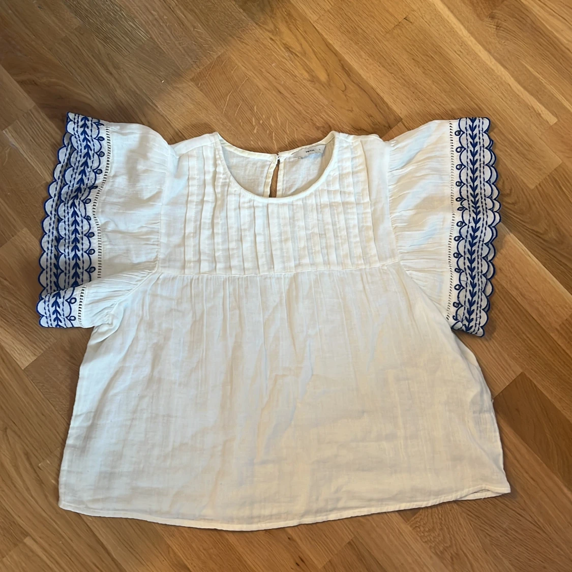 Vit blus med blå brodyr från Pigalle