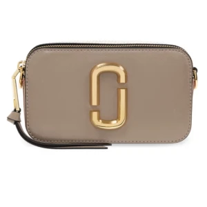 Beige axelväska från Marc Jacobs - Snygg beige axelväska från Marc Jacobs med guldigt logodetalj framtill. Väskan är i slätt skinn och har dragkedja upptill samt en svart handledsrem. Perfekt storlek för det viktigaste och en stilren accessoar till din outfit. Pris kan diskuteras privat vid snabb affär 