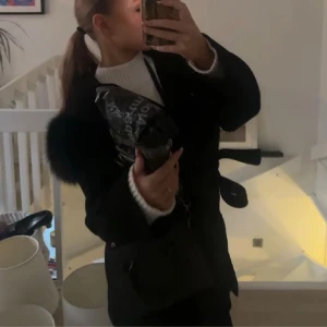 Svart kappa med päls - Säljer en svart kappa med fluffiga pälsdetaljer på axlarna och ett snyggt bälte i midjan. Bara att skriva om du vill ha fler bilder eller frågor☺️