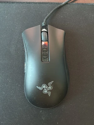 Razer DeathAdder V2 - Razer DeathAdder V2 gamingmus med Focus+ 20K DPI optisk sensor, programmerbara knappar och ergonomisk design. Kabelansluten modell i gott skick med mindre ytslitage. Perfekt för både gaming och arbete tack vare hög precision och komfort.