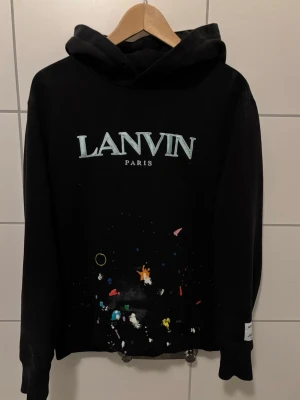 Lanvin x Gallery dept hoodie - Jag säljer en riktigt fet Lanvin x Gallery dept hoodie i storlek S. Den sitter dock mer som en M. OBS inga snören följer med. Inga defekter och är i bra skick! Bara höra av er vid frågor eller om ni vill ha mer bilder. Kvitto på tröjan finns på bild men skickas inte med.