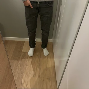 Levi's 511 grå jeans slim fit - Säljer ett par grå Levi's 511 jeans med slim passform. Jeansen har klassisk femficksdesign, svarta sömmar och Levi's ikoniska läderpatch bak i midjan. Materialet är mjukt jeans i bomull med lite stretch för extra komfort. Perfekta för dig som gillar en smalare siluett.