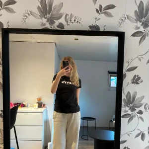 Levi's t-shirt - Svart t-shirt från Levi's med klassisk vit logga på bröstet. Modellen är kortärmad och har en rund halsringning. Tillverkad i mjuk bomull som känns skön mot huden. Perfekt för en avslappnad och stilren look. Lite ludd på den då den legat mot en stickad tröja😅Knappt använd!