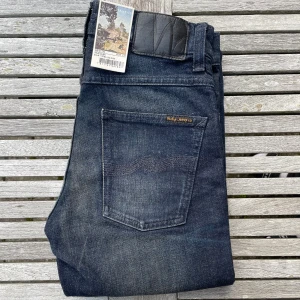 Nya Nudie Jeans Grim Tim - Säljer du dessa otroligt snygga Nudie jeans! De är storlek 28/32 och modell Grim Tim. Helt sprillans nya med tags, alltså helt oanvända! Sjukt snygg och unik tvätt och färg! Nypris är 1600 online! Hör av dig vid frågor och funderingar, priset är inte hugget i sten! 