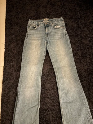 Bootcut ljusblå jeans från Lager 157 - Säljer ett par ljusblå bootcut jeans från Lager 157 Klassisk femficksmodell med dragkedja och knapp framtill. Jeansen har en snygg tvätt och sitter riktigt bra över höften. Perfekt passform för dig som gillar lite utsvängda ben. Jag är 165 cm och de är lite långa för mig. Lite trasiga precis i kanten vid ankeln på byxorna då ja trampat på de när jag gått. Storlek S. Hör av dig via E-mej eller mobil nmr då jag inte kan ta emot Swish via detta nmr e-mejl emli.com@icloud.com mobil-0728875624 😊
